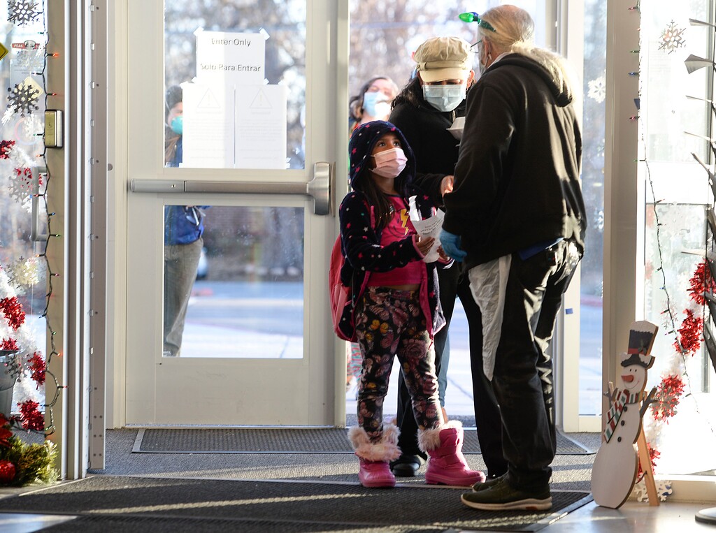 (Leah Hogsten | The Salt Lake Tribune) Cassandra Miranda and her mother Maria Miranda say goodbye to Cassandra's Neighborhood House teacher as they leave with taco bowls and burritos for dinner on Tuesday. Salt Lake City Mayor Erin Mendenhall handed out food to needy families at the Neighborhood House as part of the Nourish to Flourish program that distributes meals prepared by local restaurants to individuals and families in need, Dec. 22, 2020.