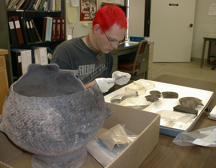 (Tribune File photo) Archaeologist and assistant museum curator Erik Ferland catalogs non-funerary artifacts at the Edge of the Cedars State Park repository for archaeological material at Blanding.