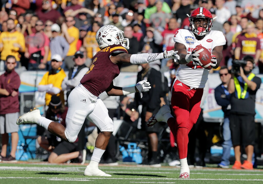 North Carolina State's Stephen Louis makes a long reception covered by Arizona State's Kobe Williams in the first half of the Sun Bowl NCAA college football game in El Paso, Texas, Friday, Dec. 29, 2017. (Mark Lambie/The El Paso Times via AP)