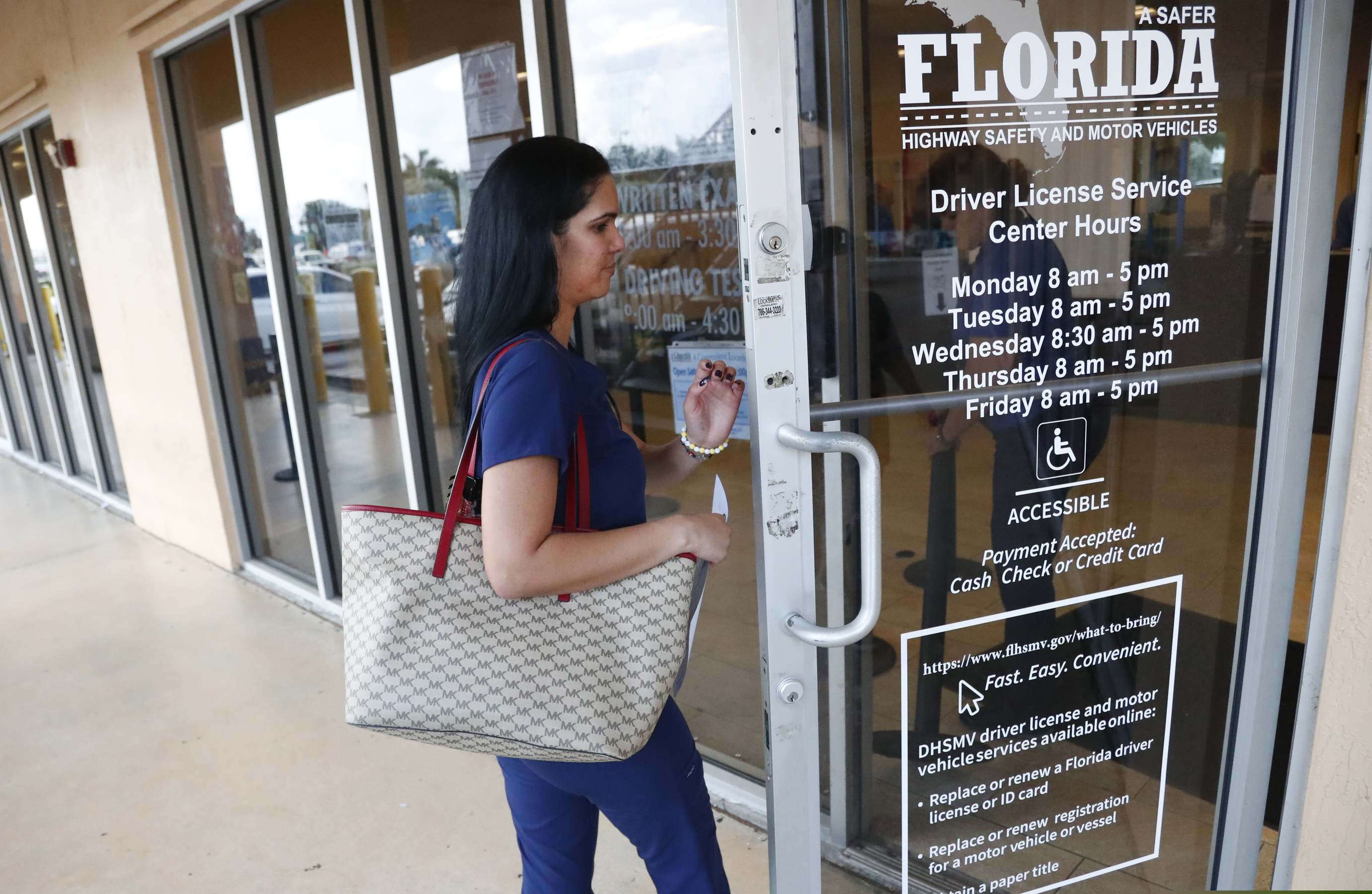(Wilfredo Lee | AP) A woman enters a Florida Highway Safety and Motor Vehicles drivers license service center, Tuesday, Oct. 8, 2019, in Hialeah, Fla. The U.S. Census Bureau has asked the 50 states for drivers' license information, months after President Donald Trump ordered the collection of citizenship information.