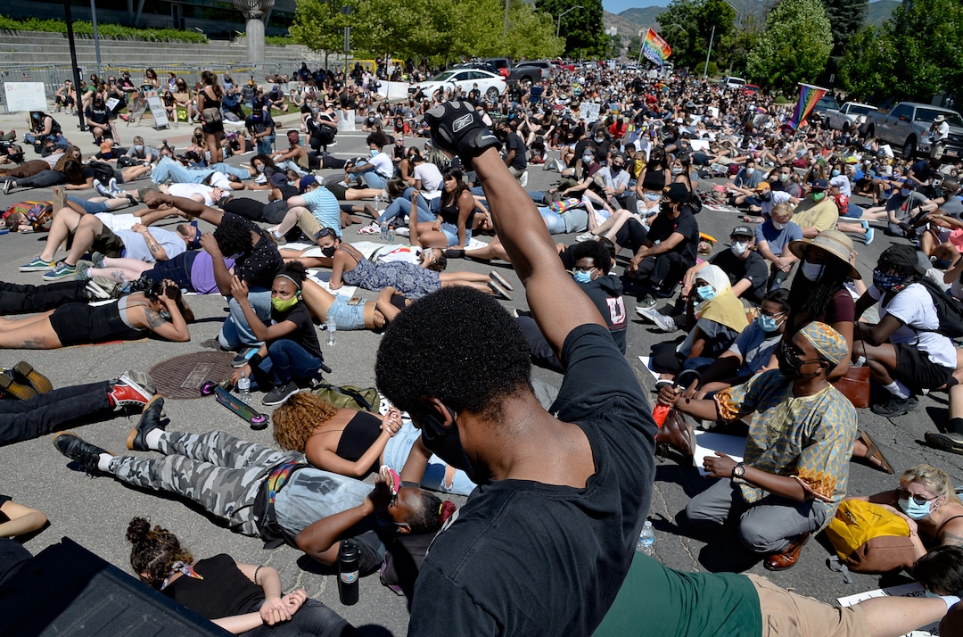 (Francisco Kjolseth  |  The Salt Lake Tribune) Mac Allred raises his fist as people lay on the street outside the Salt Lake City Public Safety Building for a protest as part of a series of Juneteenth celebrations on Friday, June 19, 2020.