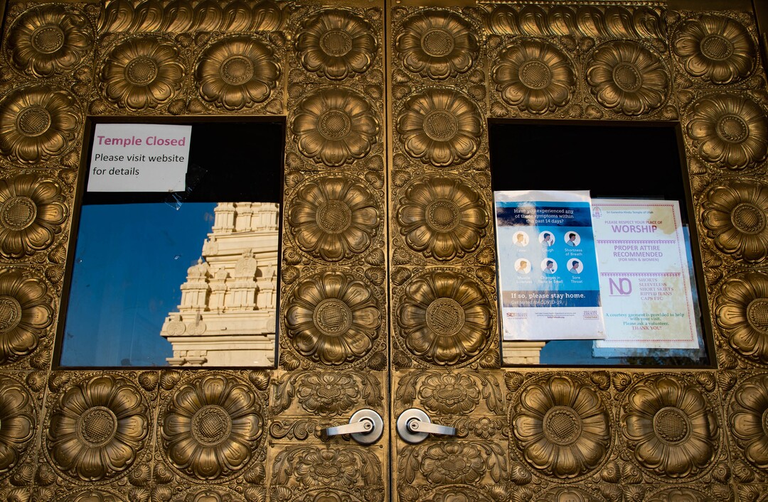 (Francisco Kjolseth  |  The Salt Lake Tribune) Stickers and signs promoting social distancing are placed on the ground outside of the Sri Ganesha Hindu Temple in South Jordan in an effort to maintain safety during the coronavirus pandemic. Thought the temple remains closed on weekdays, a few slots are available for signup on the weekend under limited hours.