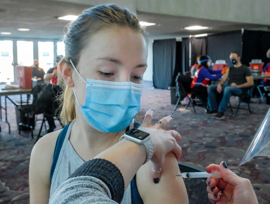 (Leah Hogsten | Tribune file photo) Abbie Lunda, an LPN with Ivy Lane Pediatrics in Ogden receives the COVID-19 vaccine on Tuesday. The Weber-Morgan Health Department began distributing the COVID-19 vaccine to health care workers in non-hospital settings at Weber State University's Dee Events Center, Jan. 5, 2020.