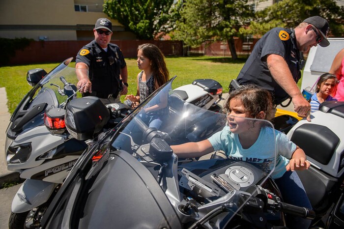 (Trent Nelson | The Salt Lake Tribune)Salt Lake City police officers Scott Hall and Michael Blackburn demo their bikes for Catalina, Faith, and Mia Cardenes Wednesday June 13, 2018, during an event at a Salt Lake City 7-Eleven store promoting the donation of 7,500 Slurpee coupons by the company for police officers to hand out to children.
