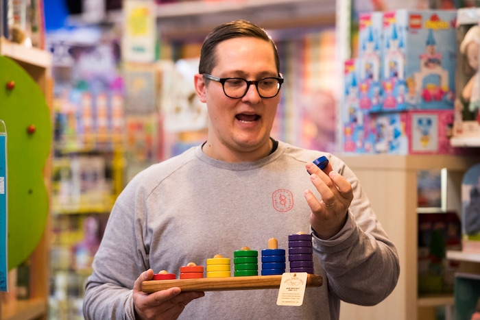 (Rick Egan  |  The Salt Lake Tribune)       Casey Sartain talks about some of the unique toys they sell at The Tutoring Toy on Foothill Drive, such as Papa Don's home made toys from Oregon, Thursday, March 22, 2018.
