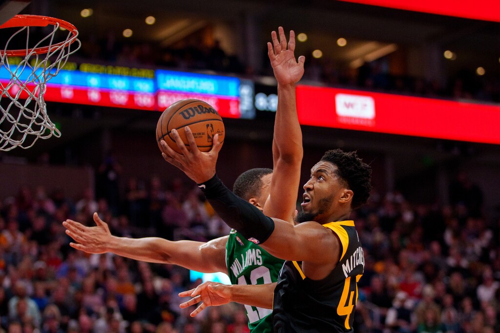 (Trent Nelson  |  The Salt Lake Tribune) Utah Jazz guard Donovan Mitchell (45) shoots, with Boston Celtics forward Grant Williams (12) defending, as the Utah Jazz host the Boston Celtics, NBA basketball in Salt Lake City on Friday, Dec. 3, 2021.