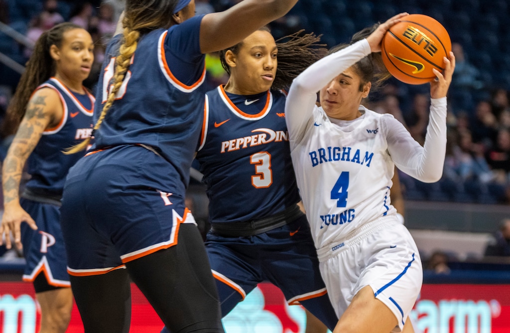 (Rick Egan | The Salt Lake Tribune) BYU Cougars guard Arielle Mackey-Williams (4) takes the ball inside as Pepperdine Waves guard Jayda Ruffus-Milner (3) defends, in women's basketball action between the BYU Cougars and the Pepperdine Waves, at the Marriott Center in Provo, on Thursday, Feb. 10, 2022. Judkins scored his 450th win tonight.