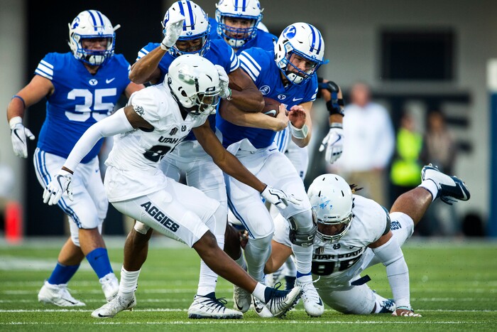 (Chris Detrick  |  The Salt Lake Tribune)  Utah State Aggies cornerback Ja'Marcus Ingram (36) and Utah State Aggies tight end Carson Terrell (86) stop Brigham Young Cougars quarterback Beau Hoge (7) during the game at Merlin Olsen Field at Maverik Stadium Friday, September 29, 2017.