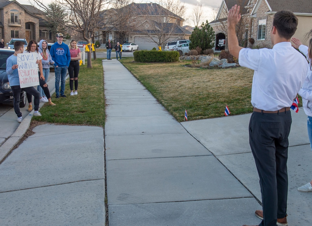 (Rick Egan  |  Tribune file photo)      Elder Ethan Borg waves from his driveway as friends and neighbors honk and wave as he returns home from his Latter-day Saint mission in Thailand, Tuesday, March 24, 2020.
