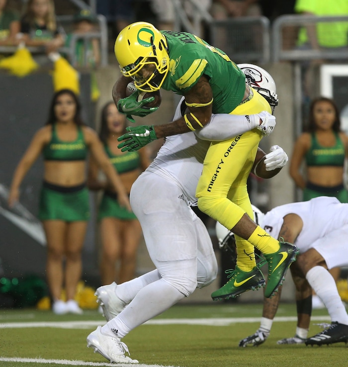 Oregon's Charles Nelson scores a touchdown during the third quarter despite the effort of Southern Utah's Elijah Holt during an NCAA college football game Saturday, Sept. 2, 2017, in Eugene, Ore. (AP Photo/Chris Pietsch)