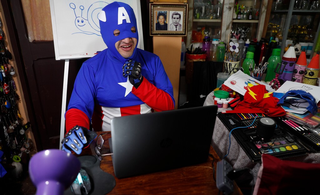 (Juan Karita | AP photo)

Art teacher Jorge Manolo Villarroel, wearing a Captain America costume, teaches an online class from his home, amid the new coronavirus pandemic in La Paz, Bolivia, Tuesday, June 9, 2020. His classes have become so popular that siblings fight for computer time to learn from this costumed teacher.