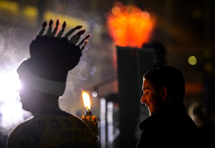 (Steve Griffin  |  The Salt Lake Tribune) The public joined  Rabbi Benny Zippel of Chabad Lubavitch as he lights a giant menorah for the first night of Hanukkah, the Jewish eight day festival of lights outside, Abravanel Hall in Salt Lake City Tuesday December 12, 2017.