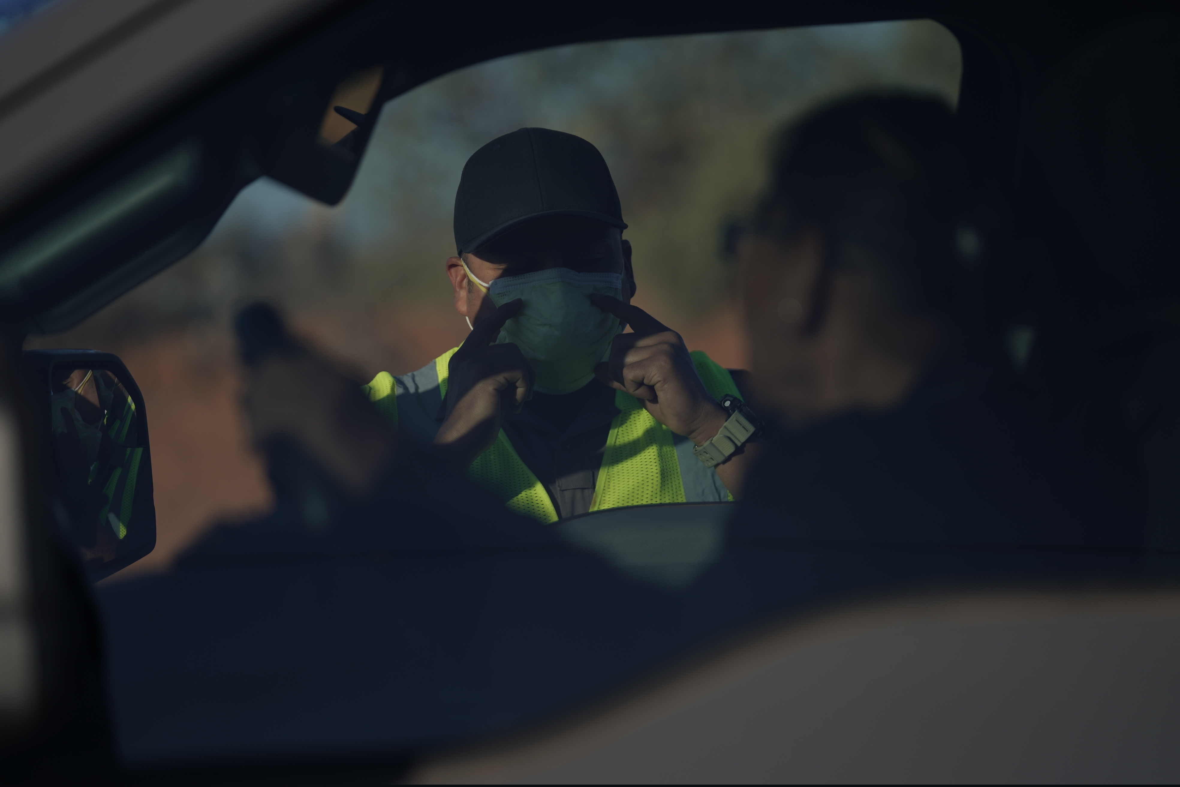 An officer with the Navajo Nation Police talks to a driver at a roadblock in Tuba City, Ariz., on the Navajo reservation on April 22, 2020. The roadblock was to inform residents of evening and weekend curfews, hand washing, and wearing a face mask to help control the spread of COVID-19. (AP Photo/Carolyn Kaster)