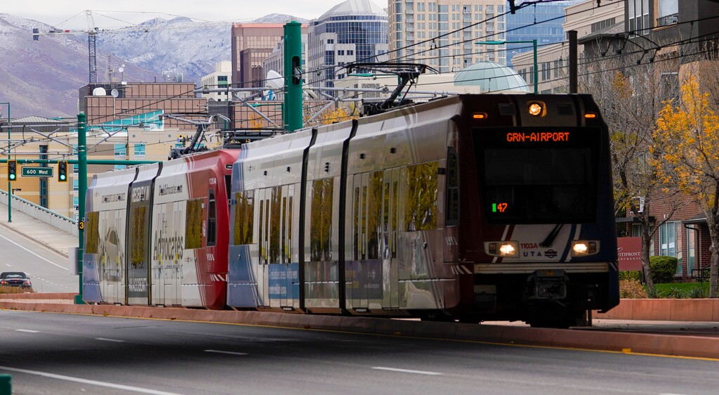 (Leah Hogsten | The Salt Lake Tribune)  A Trax train moves along North Temple in Salt Lake City, Oct. 27, 2021. 