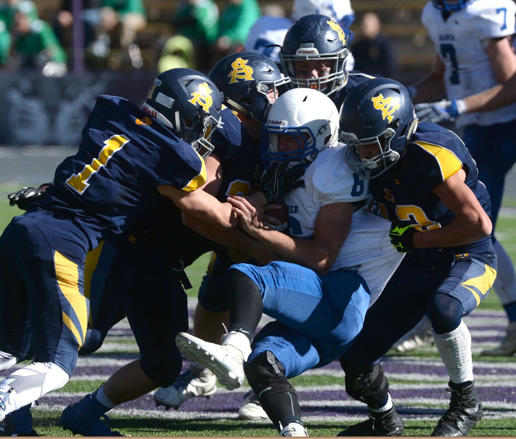 Steve Griffin | The Salt Lake Tribune
Summit Academy defense wraps up Beaver quarterback Jordan Hardy during their state playoff game last season.