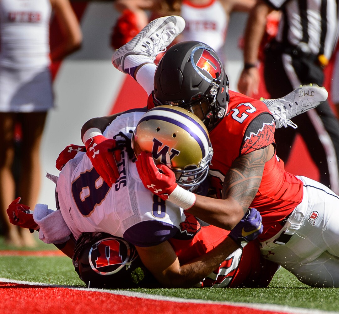 Trent Nelson  |  The Salt Lake TribuneUtah Utes defensive back Jason Thompson (10) and defensive back Julian Blackmon (23) tackle Washington Huskies wide receiver Dante Pettis (8) as the University of Utah faces Washington, college football at Rice-Eccles Stadium in Salt Lake City, Saturday October 29, 2016.