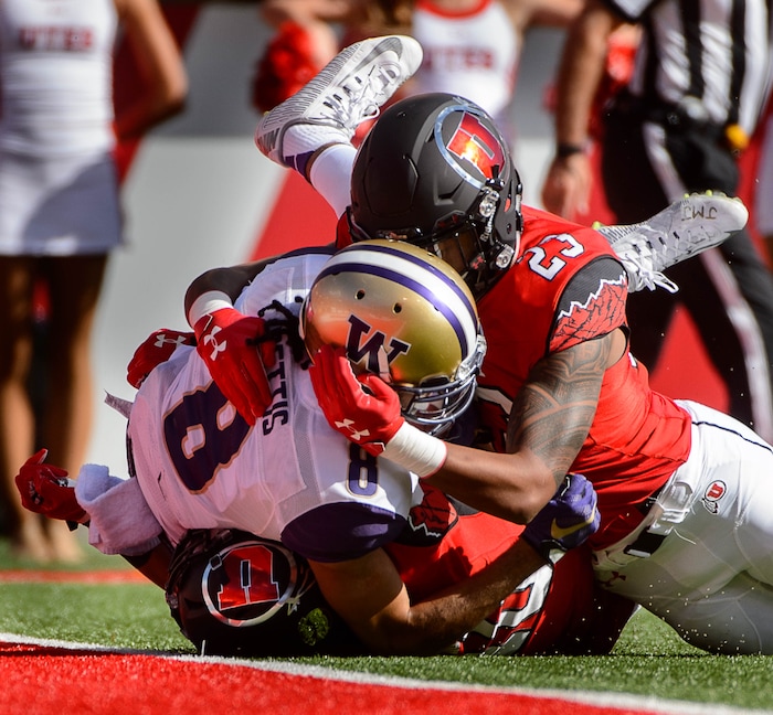 Trent Nelson  |  The Salt Lake Tribune
Utah Utes defensive back Jason Thompson (10) and defensive back Julian Blackmon (23) tackle Washington Huskies wide receiver Dante Pettis (8) as the University of Utah faces Washington, college football at Rice-Eccles Stadium in Salt Lake City, Saturday October 29, 2016.