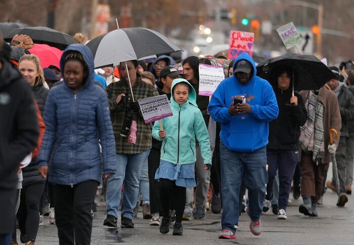 (Leah Hogsten | The Salt Lake Tribune) Jahmal Hasliip and his daughter Jayda, 9, right,participate in the march from East High School to Kingsbury Hall on Monday. To commemorate the legacy and work of Martin Luther King, Jr. and many other activists fighting for racial equality during the Civil Rights movement, the University of Utah's office of Equity, Diversity & Inclusion kicked off MLK Week 2023 with a rally at East High School, followed by a march to Kingsbury Hall, Jan. 16, 2023. 