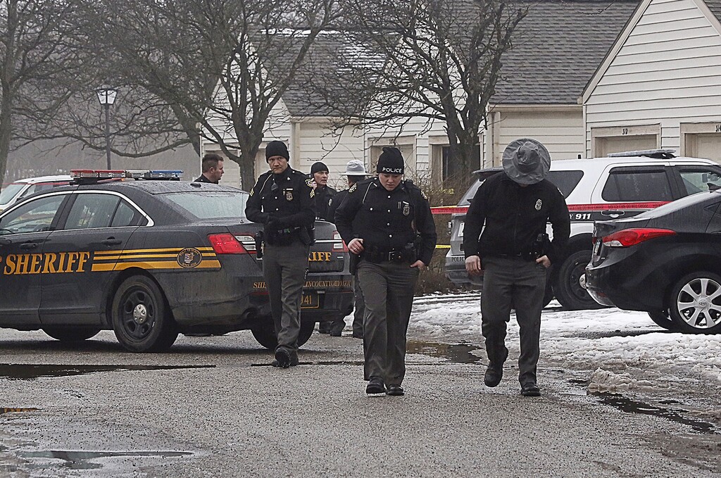 Police investigate the scene of a shooting in Westerville, Ohio, on Saturday, Feb. 10, 2018.  Westerville police have confirmed that two officers have been fatally shot at a home in the Columbus suburb.  A police statement says the officers responded to a 911 hang-up call around 11:30 a.m. and were shot after they arrived at a residence.  A suspect is reportedly in custody.    (Tom Dodge/The Columbus Dispatch via AP)