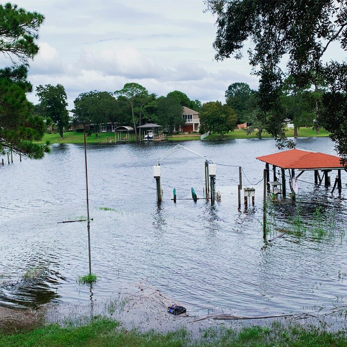 (April Sarver | The Associated Press) This photo provided by April Sarver shows a flooded neighborhood boat dock in Fort Walton Beach, Fla., Tuesday, Oct. 9, 2018. A fast and furious Hurricane Michael sped toward the Florida Panhandle on Tuesday with 120 mph winds and a potential storm surge of 13 feet, giving tens of thousands of people precious little time to get out or board up.