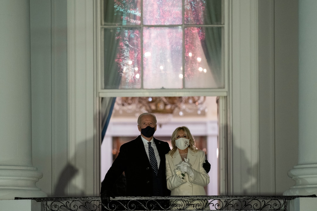 President Joe Biden and first lady Jill Biden watch fireworks from the White House, Wednesday, Jan. 20, 2021, in Washington. (AP Photo/Evan Vucci)