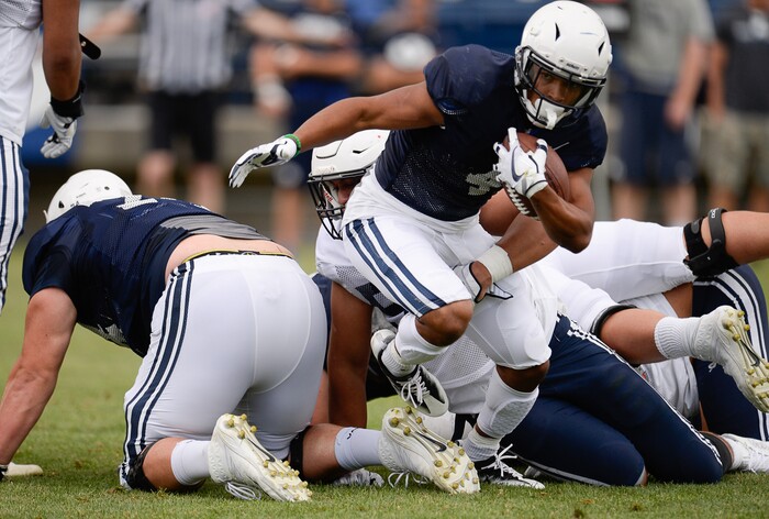 (Francisco Kjolseth  |  The Salt Lake Tribune)  Trey Dye squeezes out from the defense as BYU holds a scrimmage at LaVell Edwards Stadium in Provo on Thursday, Aug. 10, 2017.