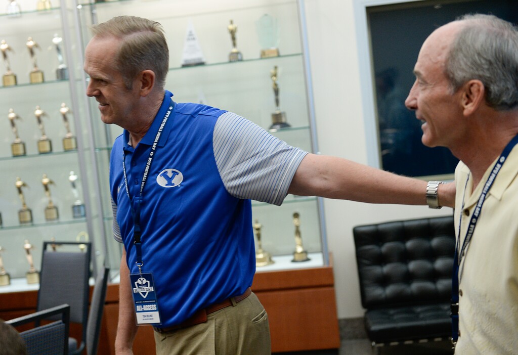 (Francisco Kjolseth | The Salt Lake Tribune) Current BYU athletic director Tom Holmoe, left, greets his predecessor Rondo Fehlberg as BYU hosts their eighth-annual football media day at the BYU-Broadcasting Building on Friday, June 22, 2018.
