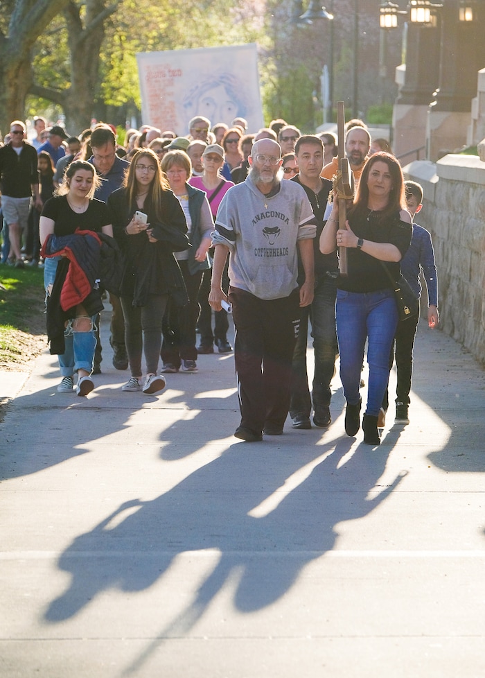 (Francisco Kjolseth  |  The Salt Lake Tribune)  Christians march through streets of Salt Lake City on Good Friday to symbolically mark Jesus' carrying the cross to his crucifixion beginning at Cathedral of the Madeleine.