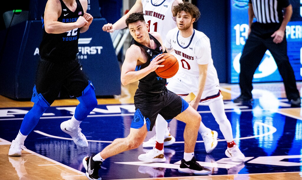 (Isaac Hale | Special to The Tribune) Brigham Young University guard Alex Barcello (13) looks to pass the ball out while guarded by St. Mary's College guard Logan Johnson (0) during a game between the BYU Cougars and the Saint Mary’s College of California Gaels held at the Marriott Center in Provo on Saturday, Feb. 27, 2021.
