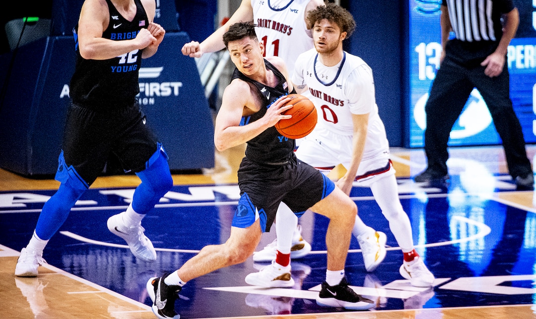 (Isaac Hale | Special to The Tribune) Brigham Young University guard Alex Barcello (13) looks to pass the ball out while guarded by St. Mary's College guard Logan Johnson (0) during a game between the BYU Cougars and the Saint Mary’s College of California Gaels held at the Marriott Center in Provo on Saturday, Feb. 27, 2021.