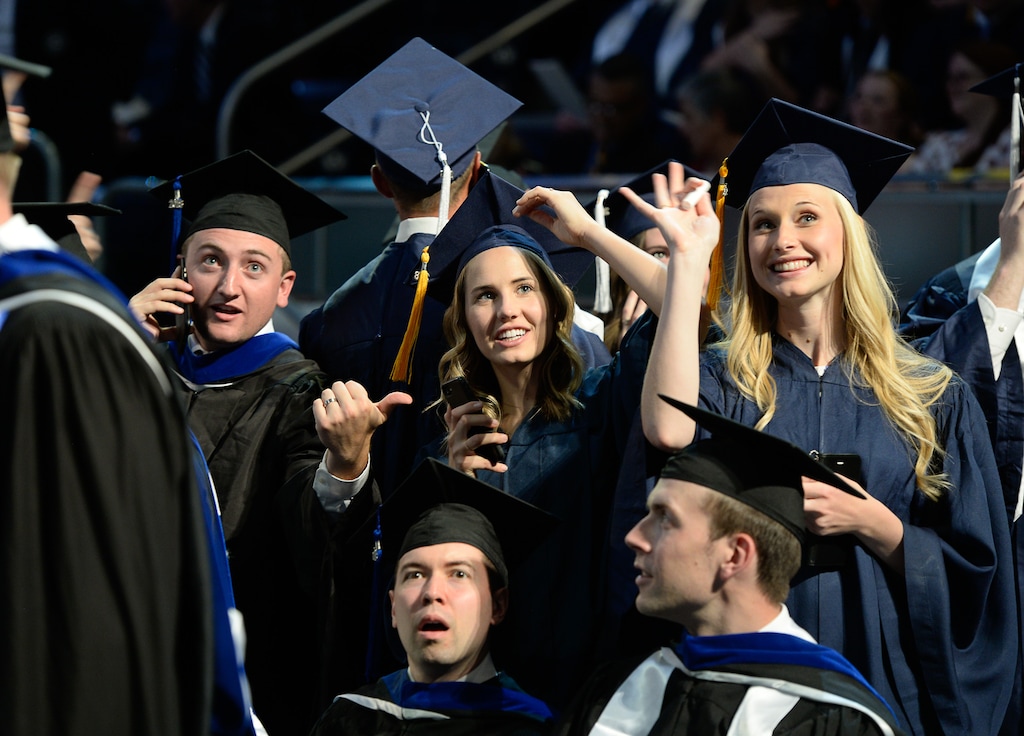 (Francisco Kjolseth | The Salt Lake Tribune) Graduates find loved ones in the audience as Brigham Young University in Provo holds its 2018 commencement Thursday, April 26, at the Marriott Center. This is one of the largest classes ever to graduate from BYU due to the number of female students who temporarily left campus around 2013-14 to serve missions.