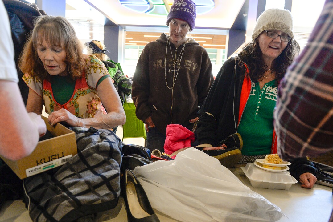 Leah Hogsten  |  The Salt Lake Tribune Amy Hamilton, center, waits for a pair of new shoes at the Utah Jazz and the Larry H. Miller Group sponsored annual “We Care – We Share” benefit, Monday, Nov 19, 2018.