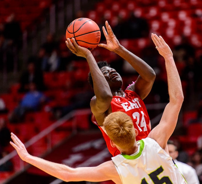 (Trent Nelson | The Salt Lake Tribune)  East vs. Timpanogos, 5A State high school basketball tournament at the Huntsman Center in Salt Lake City, Wednesday Feb. 28, 2018. East's Andre Mulibea (24) shoots over Timpanogos's Tyler Walker (15).
