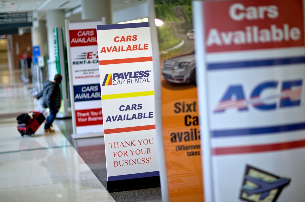 (AP Photo | David Goldman) Banners advertising cars available for rent stand along the check-in counters of the car rental center at Hartsfield-Jackson Airport, Atlanta, Wednesday, Nov. 27, 2013.