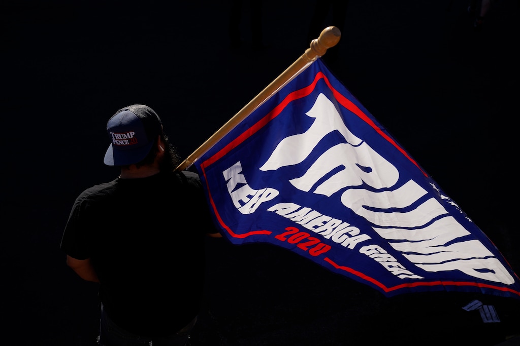 (John Locher | AP photo)

A supporter of President Donald Trump carries a Trump flag before a news conference by the Trump campaign in front of the Clark County Election Department, Thursday, Nov. 5, 2020, in Las Vegas.