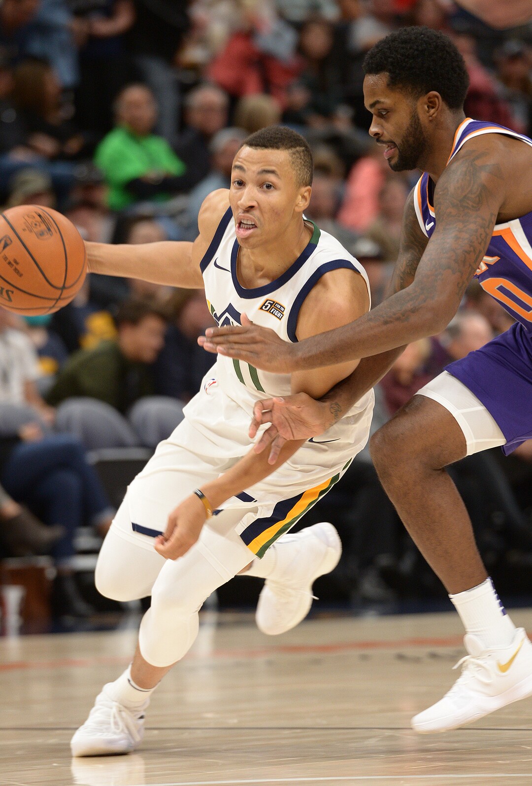 (Leah Hogsten  |  The Salt Lake Tribune)  Utah Jazz guard Dante Exum (11) fights past Phoenix Suns forward Marquese Chriss (0). The Utah Jazz defeated the Phoenix Suns 112-101 during preseason NBA basketball at Vivint Smart Home Arena in Salt Lake City, October 6, 2017.