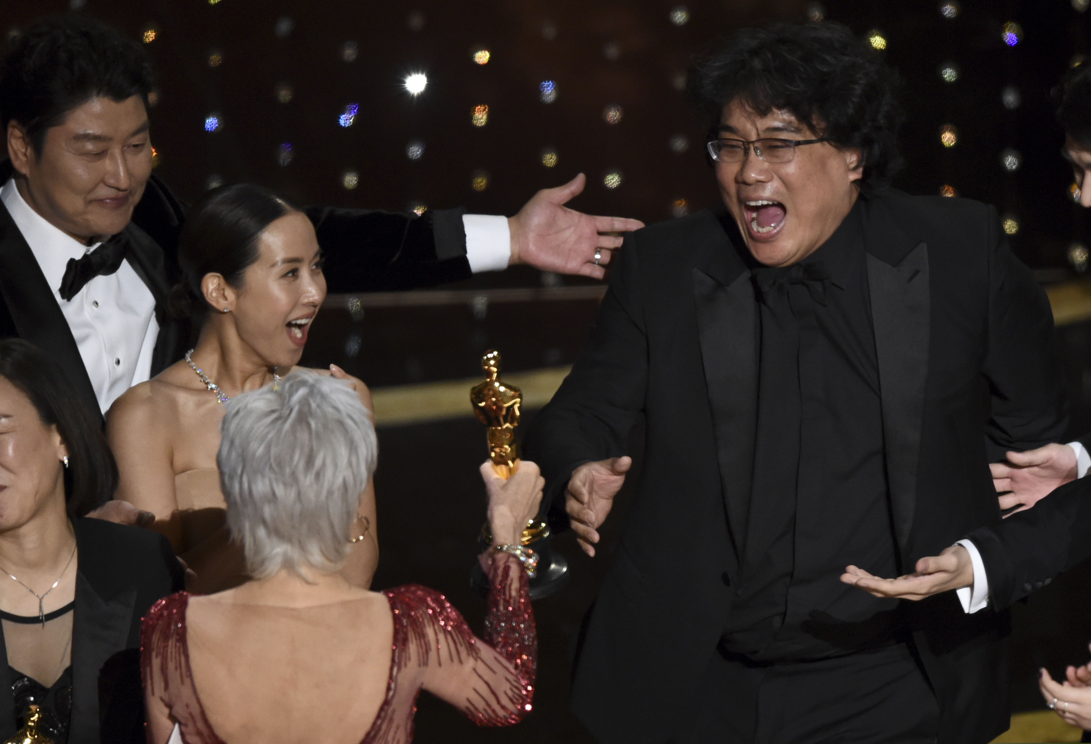 (Chris Pizzello | AP)  Bong Joon Ho, right, reacts as he is presented with the award for best picture for "Parasite" from presenter Jane Fonda at the Oscars on Sunday, Feb. 9, 2020, at the Dolby Theatre in Los Angeles. Looking on from left are Kang-Ho Song and Kwak Sin Ae.