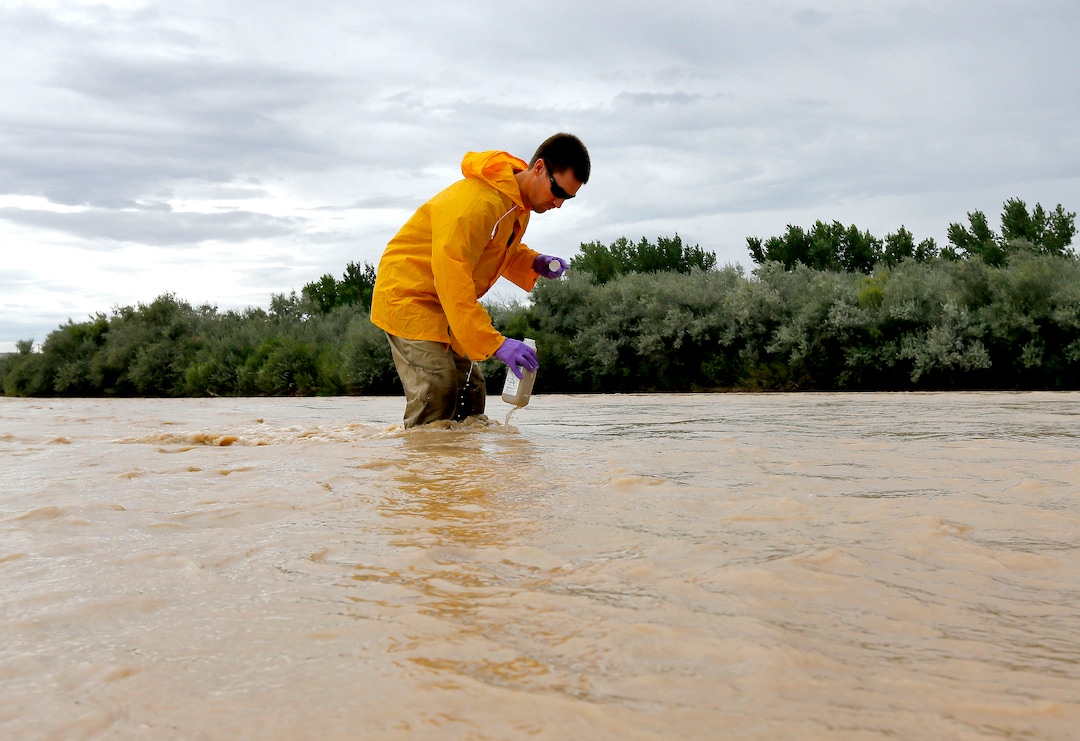 Hydrologic Technician Ryan Parker gathers water samples from the San Juan River, Tuesday, Aug. 11, 2015, in Montezuma Creek, Utah. A spill containing lead and arsenic  from the abandoned Gold King Mine in Silverton, Colo., has been leaking into the Animas River, which flows into the San Juan River in Southern Utah, since last Wednesday. The spill was caused by a mining and safety team working for the EPA.  (AP Photo/Matt York) 