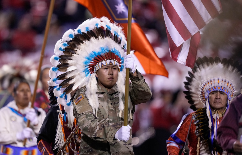 (Francisco Kjolseth |The Salt Lake Tribune) Ute veteran Robbie Cuch wears a war bonnet as members of the Ute Indian Tribe are honored during a Utah Utes football game on Oct. 19, 2024. In a filing to the U.S. Supreme Court, the Ute Indian Tribe says that Utah's public lands lawsuit is "an existential threat" to the tribe.