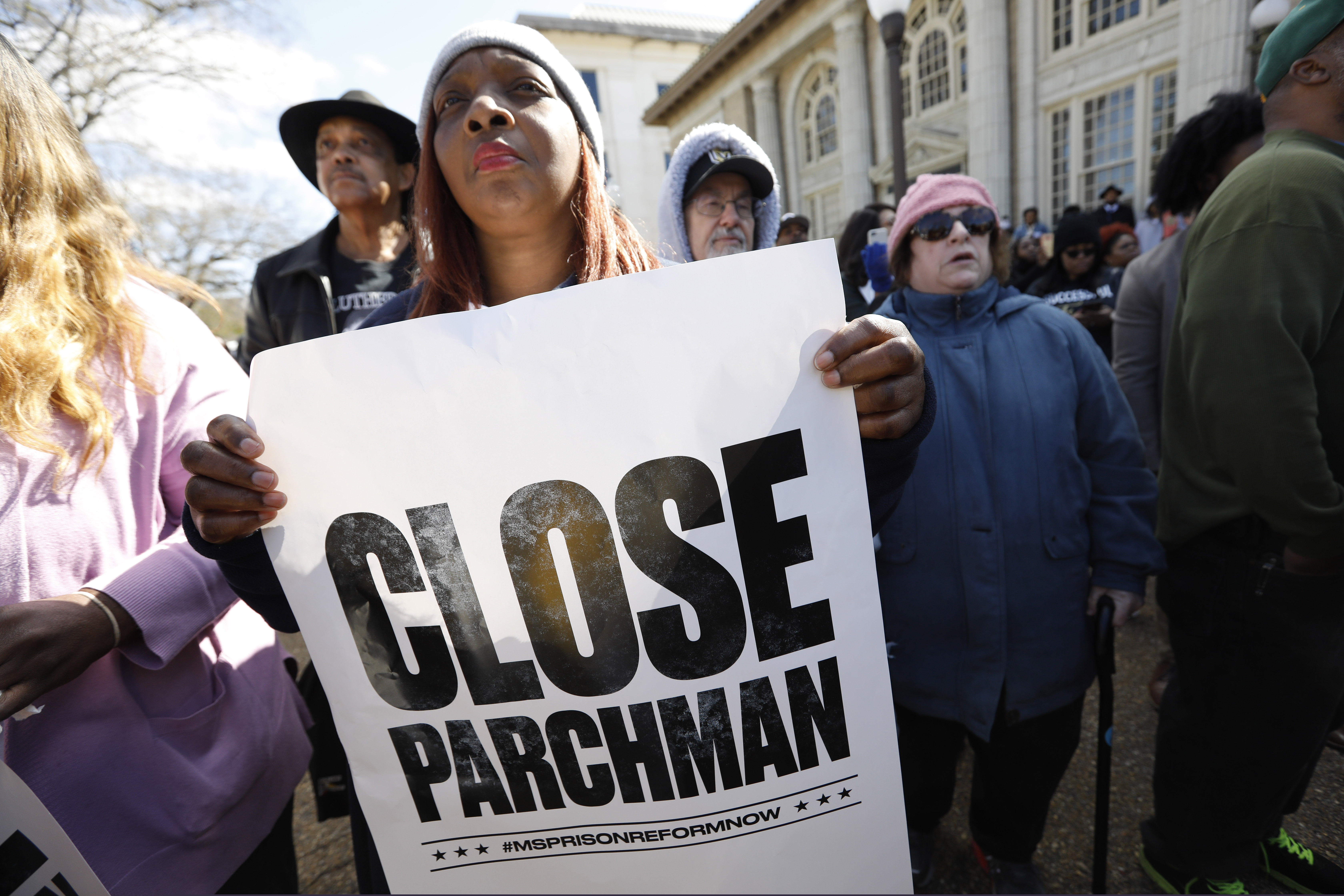 (Rogelio V. Solis | AP) Many attendees of a rally at the Mississippi Capitol in Jackson, carried signs that protested conditions in prisons where inmates have been killed in violent clashes in recent weeks, Friday, Jan. 24, 2020. They called upon the administration to specifically close the Mississippi State Penitentiary in Parchman, where a number of deaths have occurred.