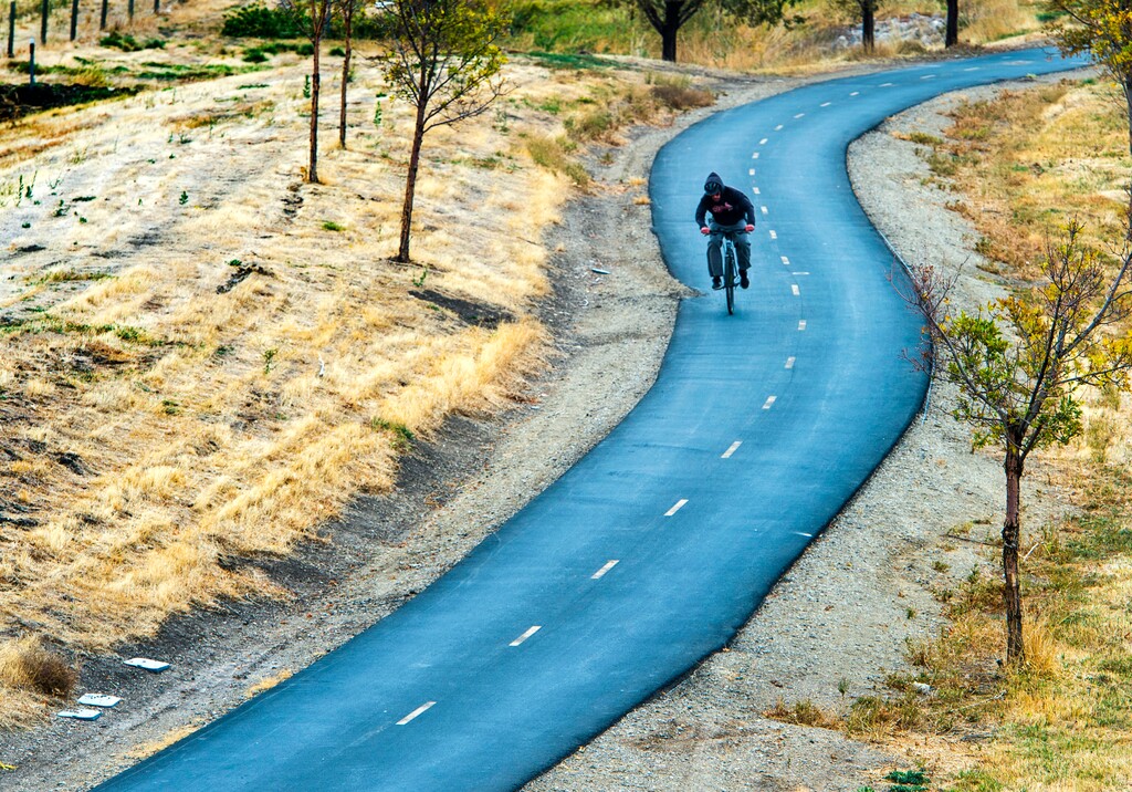 (Rick Egan  |  The Salt Lake Tribune)    A cyclist rides along the  Legacy Parkway Trail near Farmington. Utah now has nearly 1,000 mapped miles connecting cyclists to neighboring states.
