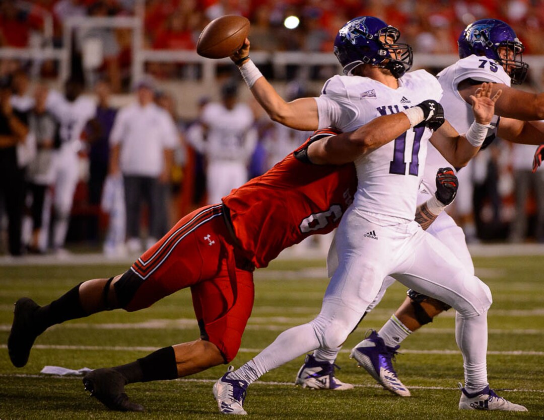 (Trent Nelson | The Salt Lake Tribune)  Weber State Wildcats quarterback Kaden Jenks (11) passes as Utah Utes defensive end Bradlee Anae (6) closes in, as the University of Utah Utes host the Weber State Wildcats, Thursday Aug. 30, 2018 at Rice-Eccles Stadium in Salt Lake City.