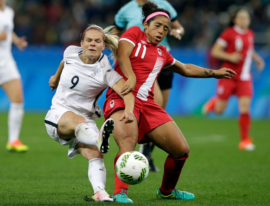 Canada's Desiree Scott, right, and France's Eugenie Le Sommer fight for the ball during a quarterfinal match of the women's Olympic soccer tournament in Sao Paulo, Brazil, Friday Aug. 12, 2016.(AP Photo/Nelson Antoine)