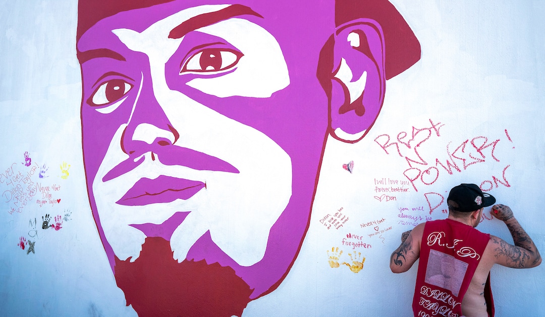 (Rick Egan | The Salt Lake Tribune) Josh Siegel, writes a message next to the mural of his brother, Dillon Taylor, who was shot by the police 7 years ago. Wednesday, Aug. 11, 2021.
