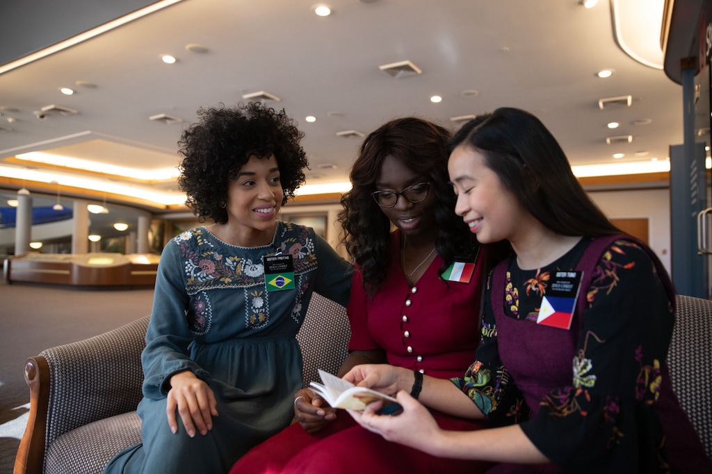 (Photo courtesy of The Church of Jesus Christ of Latter-day Saints)
Missionaries Sister Freitas, left, from Brazil; Sister Zainab, center, from Italy; and Sister Tigno, from the Philippines, serving on Temple Square, review the new “Missionary Standards for Disciples of Jesus Christ.”