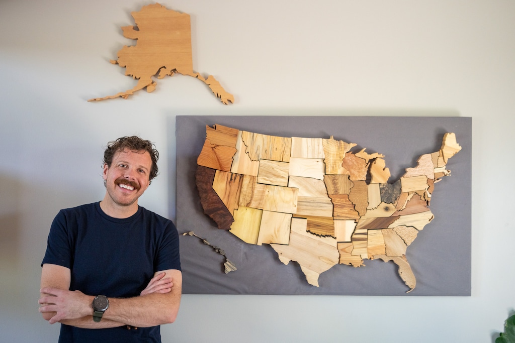 (Trent Nelson  |  The Salt Lake Tribune) Justin Davies with his map of all the states using wood from each state's tree, in Sandy on Thursday, June 23, 2022.