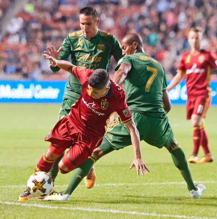 (Michael Mangum  |  Special to the Tribune)  Real Salt Lake forward Jefferson Savarino (7) weaves around Portland Timbers defender Roy Miller (7), right, and midfielder David Guzman during their MLS match at Rio Tinto Stadium in Sandy, UT on Saturday, September 16, 2017.