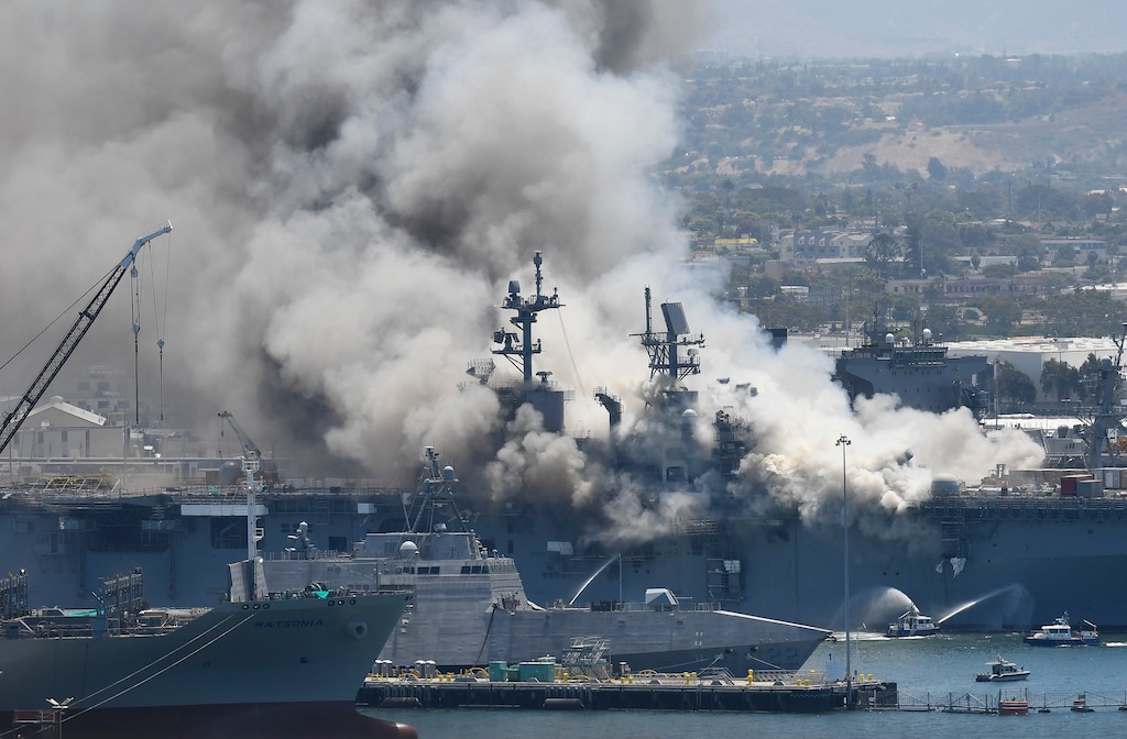 (Denis Poroy | The Associated Press) Smoke rises from the USS Bonhomme Richard at Naval Base San Diego Sunday, July 12, 2020, in San Diego after an explosion and fire Sunday on board the ship at Naval Base San Diego.