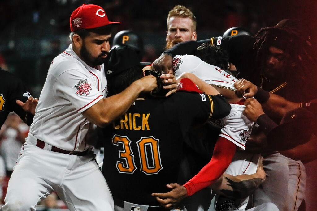 (John Minchillo | The Associated Press) Pittsburgh Pirates' Kyle Crick (30) and Cincinnati Reds' Eugenio Suarez, left, and Amir Garrett, center right, brawl during the ninth inning of a baseball game Tuesday, July 30, 2019, in Cincinnati.
