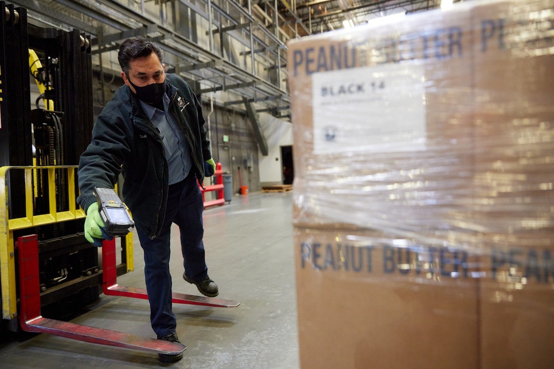 (Photo courtesy of The Church of Jesus Christ of Latter-day Saints) An employee at the Bishops Central Storehouse in Salt Lake City prepares pallets of food for donation. The  LDS Church partnered with the Black 14 Philanthropy to bring 180 tons of food to nine cities throughout the United States.